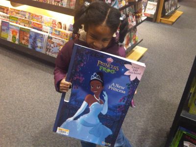 My daughter at Borders after the movie buying a Princess and the Frog coloring book. Almost as big as she is!