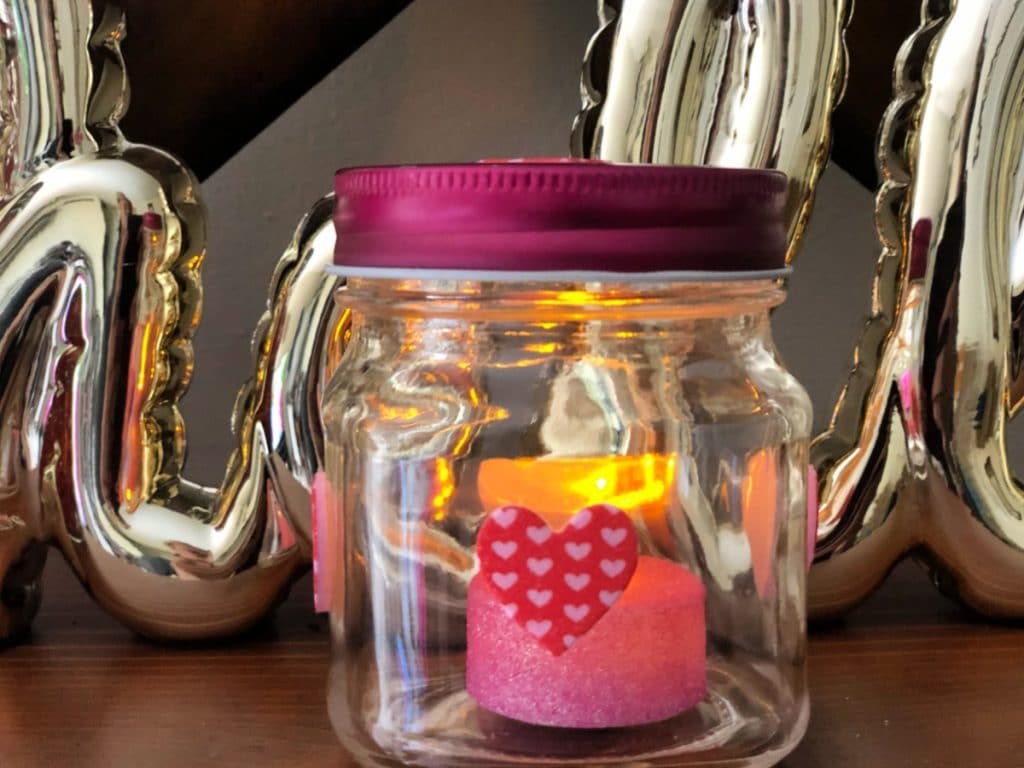 Are you looking to spice things up around the house for cupid? Try my easy to make Valentine Mason Jar Decor that is fun and lit!