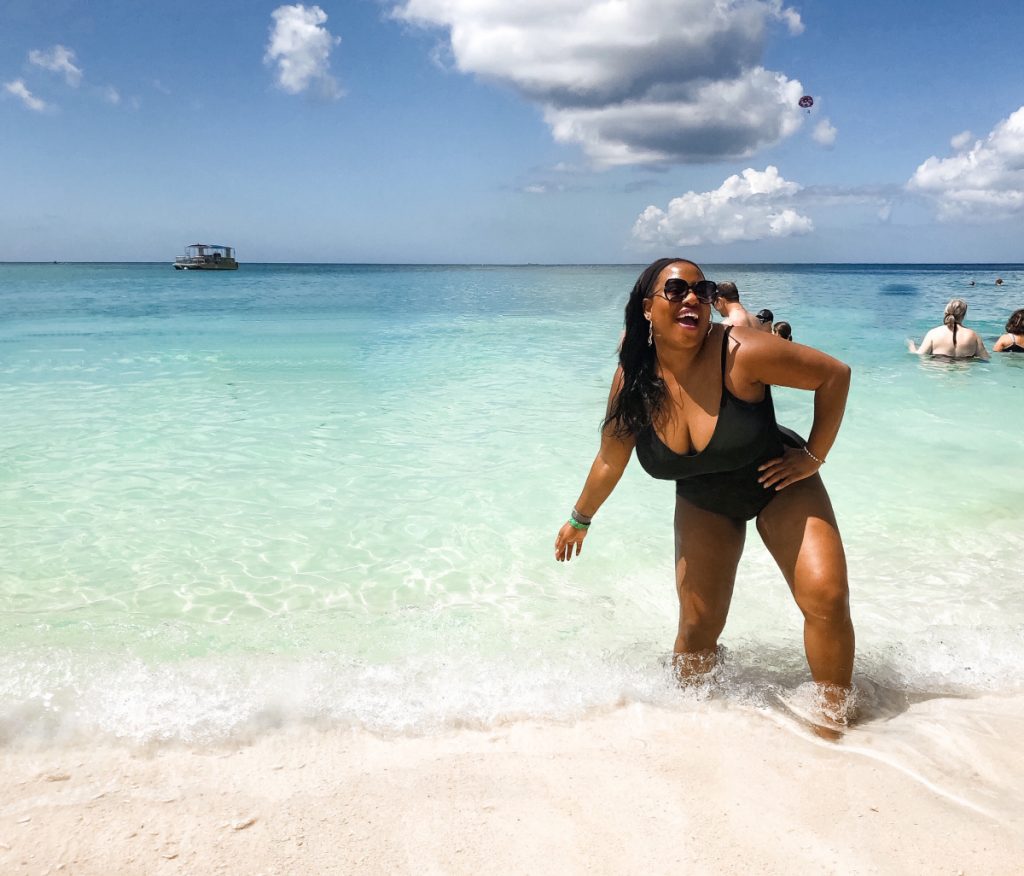 Black woman in bathing suit on 7 Mile Beach Grand Cayman