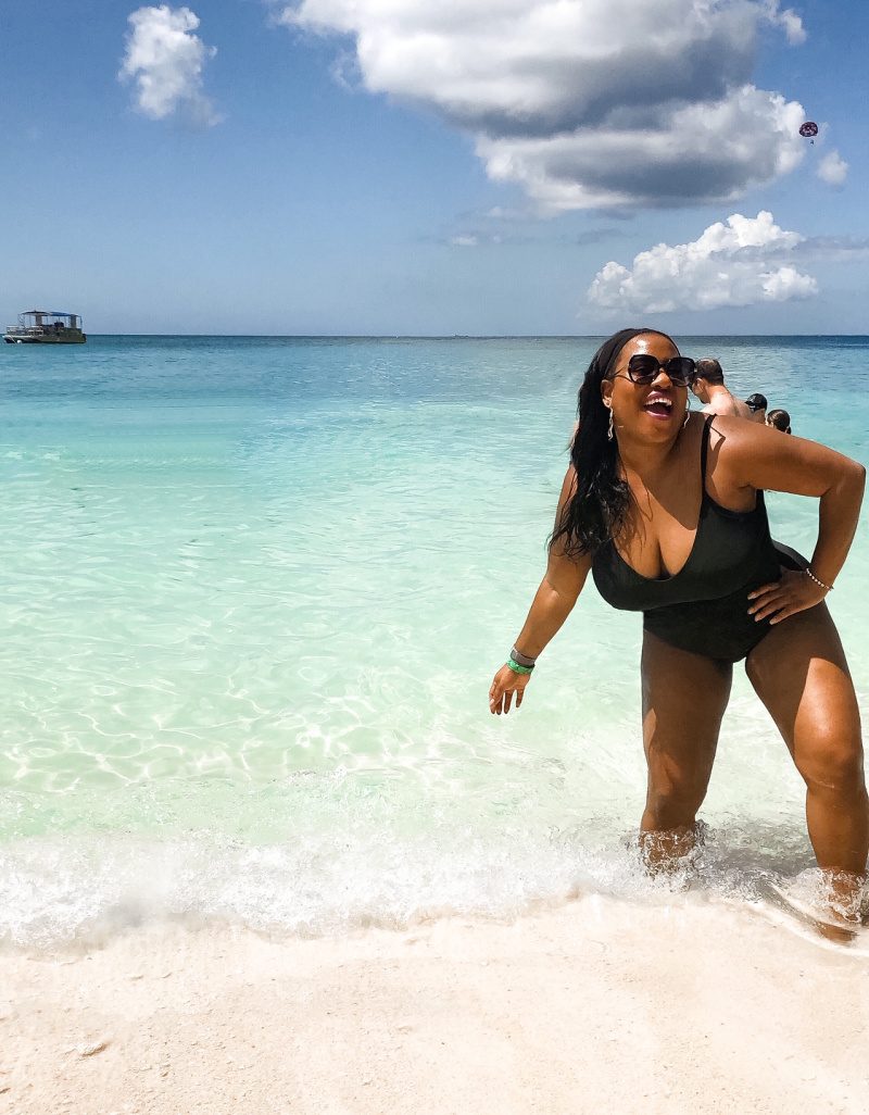 Black woman in bathing suit on 7 Mile Beach Grand Cayman